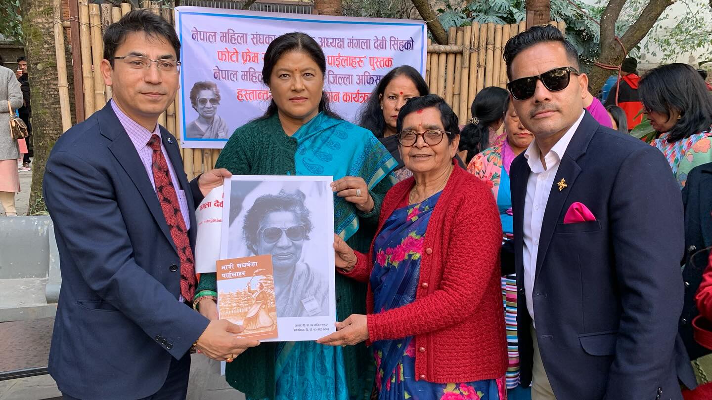 Photo frame of Mangala Devi Singh, founder president of Nepal Women's Association and handing over the book "Steps of Women's Struggle" to the entire district offices of Nepal Women's Association.
        Organizer: Mangala Devi Singh Foundation
        Chaxibari, Kathmandu.