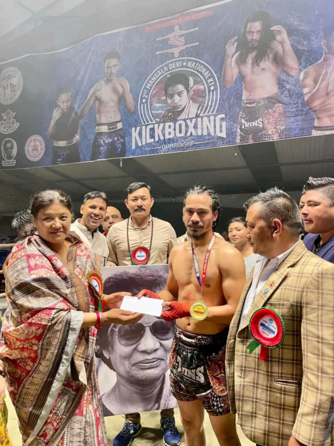 The 2nd Mangala Devi National K1 Kickboxing Championship, held on May 24-25, Friday and Saturday, was a dynamic and thrilling event. Organized in honor of Mangala Devi Singh, the championship brought together skilled kickboxers from across the nation to compete in a series of intense matches. The participants showcased their strength, agility, and martial arts prowess in the ring, striving for victory and national recognition. The event was supported by various organizations, reflecting a strong community effort to promote sportsmanship and excellence in kickboxing. Spectators witnessed fierce competition, with each match highlighting the dedication and hard work of the athletes.